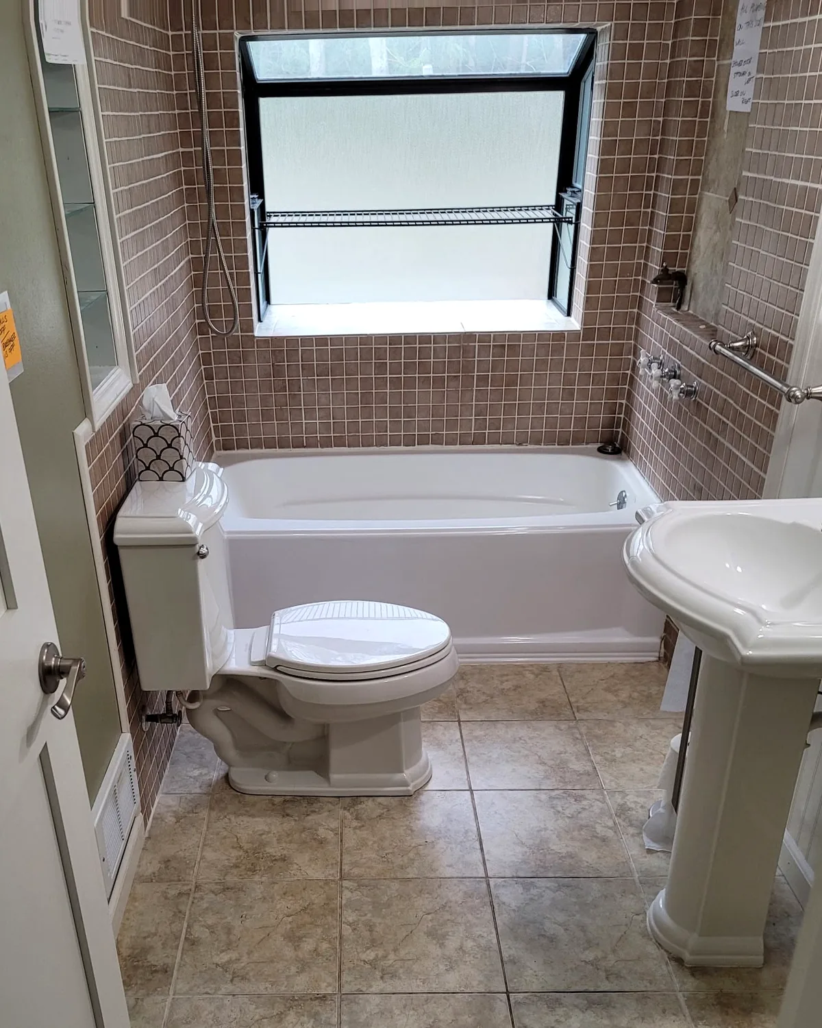 Before: bathroom with a standard bathtub and tiled walls