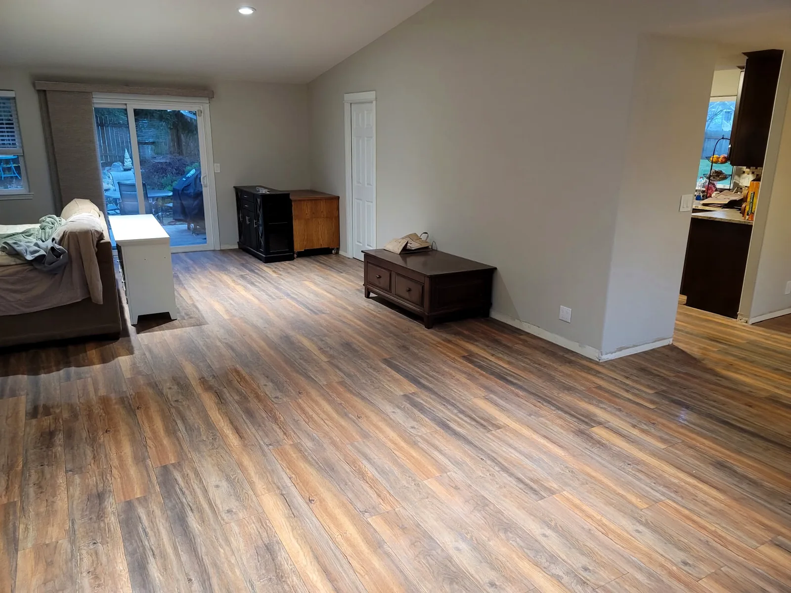 Open living area with new wood-look plank flooring